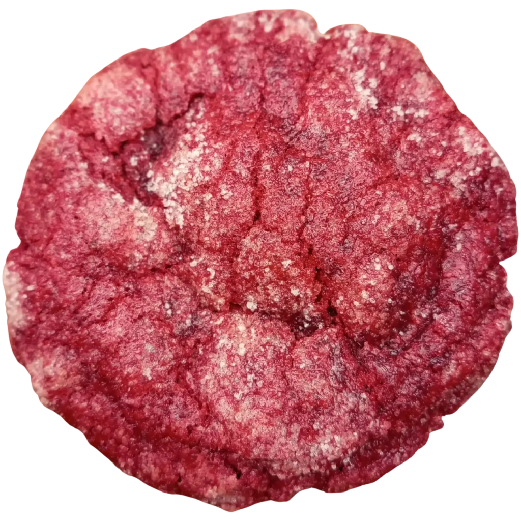 Red Velvet Magic cookie, deep red dough with a cream cheese center and a dusting of sugar crystals.